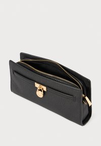 Black leather wallet with a textured finish. Features a gold zipper, front pocket, and a shiny gold clasp with logo detail.