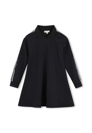 Robe polo noire à manches longues avec jupe évasée et rayures blanches à motifs le long des manches sur fond blanc.