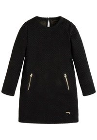 Černé šaty vyrobené z texturované tkaniny, s dlouhými rukávy, kulatým výstřihem a dvěma předními kapsami na zip se zlatavými prvky.