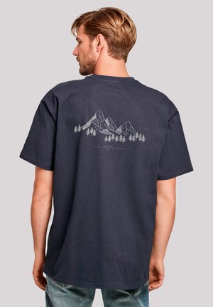 Navy t-shirt made of cotton, featuring a grey outline graphic of mountains and trees on the back, short sleeves, and a crew neck design.