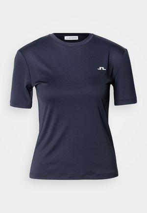 Laivastonsininen lyhythihainen paita, joka on valmistettu sileästä kankaasta. Siinä on pyöreä pääntie ja pieni valkoinen logo vasemmassa rinnassa.