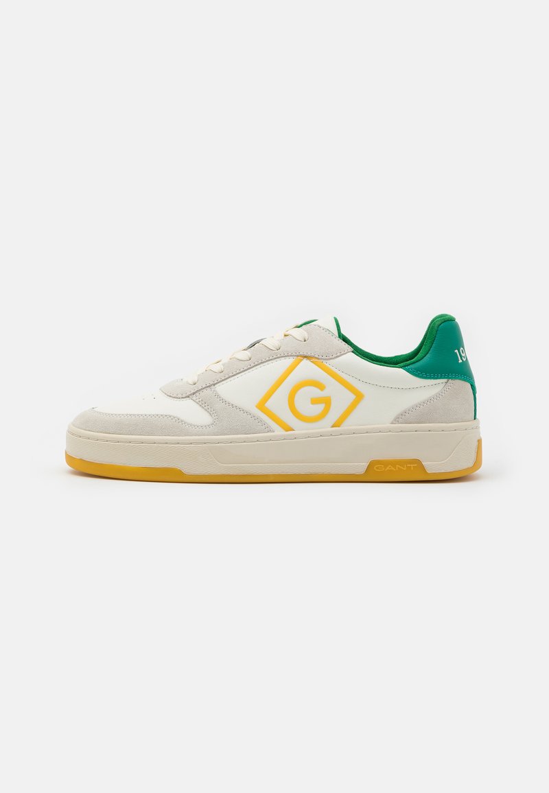 White leather and suede sneakers with yellow and green accents, featuring a diamond logo, round laces, and a textured sole.