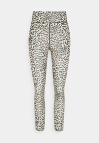 Leggings en imprimé léopard beige avec des taches noires, dotés d'une taille haute et d'un tissu lisse et extensible pour confort et liberté de mouvement.