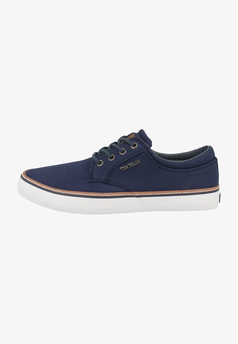 Navy canvas sneaker with white rubber sole, brown accent stitching, and round metal eyelets. Features a logo on the side.