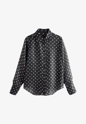 Blouse noire à manches longues avec boutons, à pois blancs et col classique, présentée sur fond blanc.
