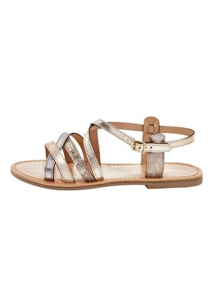 Metallic gold and silver strappy sandals with a flat sole, featuring an adjustable ankle strap and a smooth leather footbed.