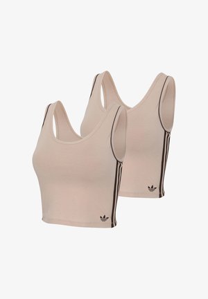 To beige cropped tanktops med mørkebrune Adidas-striber på siderne og Adidas-logo nær den nederste kant.