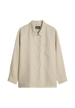 Chemise beige à manches longues avec col, fermeture éclair devant et poche poitrine, présentée sur fond blanc.