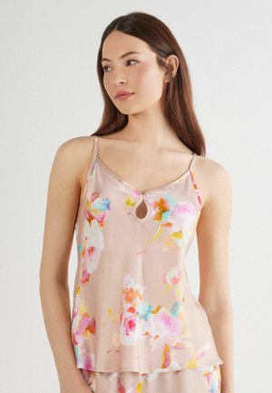 Bloemige camisole in zachtroze stof, met verstelbare dunne bandjes, een ronde sleutelgatdetail bij de halslijn en een luchtig, licht ontwerp.