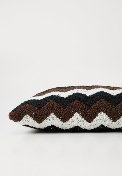 Textured cushion with a zigzag pattern in brown, white, and black. Rectangular shape, soft fabric, and a plush finish.