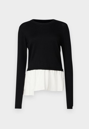 Top negru cu mânecă lungă, având un tiv ondulat alb în contrast, guler rotund și o textură moale. Proiectat cu o croială lejeră.