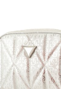 Borsa in argento trapuntata con finitura lucida, caratterizzata da un dettaglio logo triangolare e da un motivo testurizzato di lettere stilizzate sulla superficie.