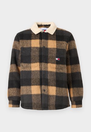 Button-up fleece shirt in black and tan check pattern. Features a cream sherpa collar and two front pockets. Soft texture throughout.