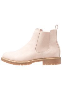 Botas Chelsea de ante rosa claro con paneles laterales elásticos, punta redondeada y suela de goma con un patrón de relieve.
