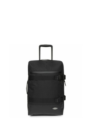 Black wheeled backpack made of durable fabric, featuring a top handle, adjustable straps, zip pocket, and front buckle accents.