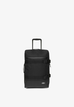 Zaino nero con ruote realizzato in un tessuto resistente, dotato di una maniglia superiore, spallacci regolabili, tasca con zip e accessori a fermaglio sul davanti.