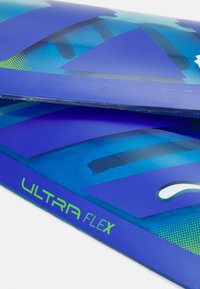 Imballaggio blu con una finitura opaca liscia, caratterizzato da un design a strati e testo verde "ULTRA FLEX". Include motivi geometrici e decorazioni.