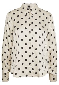 Blusa beige con pois neri, tessuto leggero, colletto a punta, maniche lunghe e chiusura frontale con bottoni.