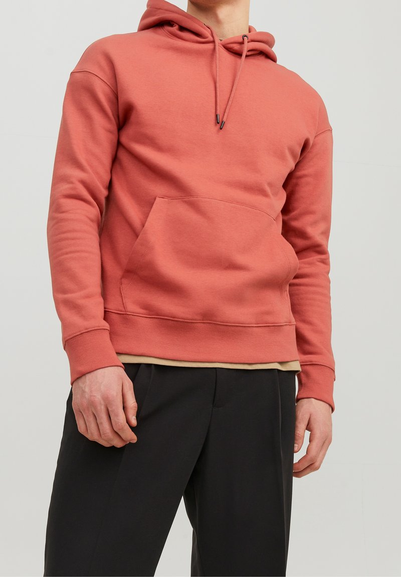 Sudadera con capucha en color coral, con un bolsillo tipo canguro en la parte delantera, puños y dobladillo acanalados, confeccionada en una suave mezcla de algodón.
