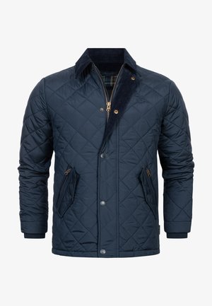 Prošívaná tmavě modrá bunda s korduroy límcem, předním zipem, dvěma zipovými kapsami a kostičkovanou podšívkou. Obsahuje diamantový vzor a patentky.