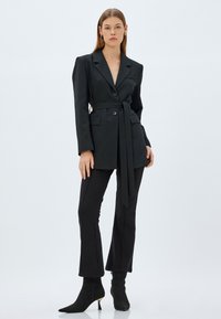 Koton FLARED - Pantaloni - black