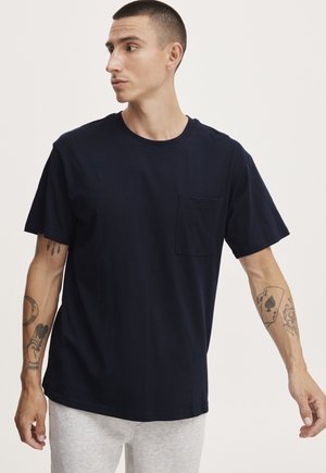 Navy blue cotton t-shirt with a round neck, short sleeves, and a chest pocket. Features a relaxed fit and smooth texture.