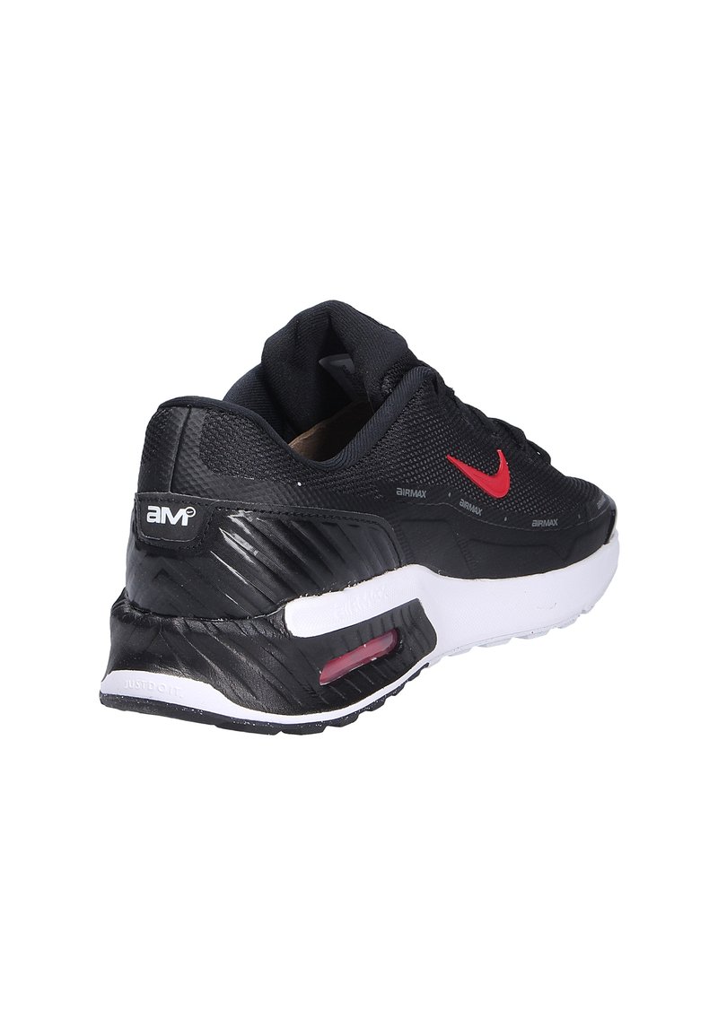 Zapatilla Nike Air Max negra con parte superior de malla texturizada, acentos del logo en rojo, entresuela blanca y amortiguación de aire visible en el talón.