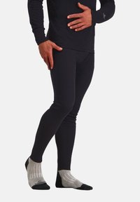 Zwarte lange mouwen top gecombineerd met zwarte leggings en grijs gestreepte enkelkousen. De stof ziet er glad en aansluitend uit.