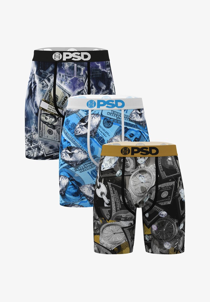Three pairs of PSD boxer briefs with designs of money, diamonds, and watches in black, blue, and mixed colors, arranged front to back.