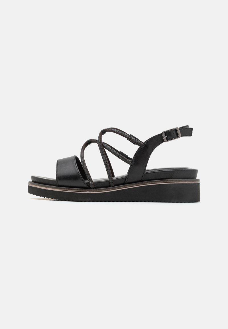 Black sandals with a platform sole, featuring a smooth leather base and crisscross fabric straps. Buckle closure on the ankle.