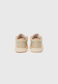 Baskets basses en cuir beige avec des accents bleu clair. Présentent une broderie sur le talon et une semelle en caoutchouc texturée pour une meilleure adhérence.