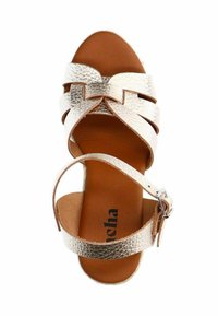 Strappy sandal featuring metallic gold textured leather upper, brown leather insole, and an ankle strap with a silver buckle.
