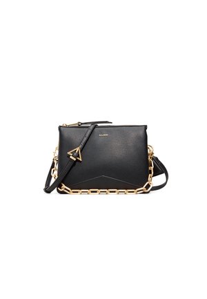 Black leather crossbody bag with a textured finish, gold chain accent, and adjustable strap; features a geometric shape and zipper closure.