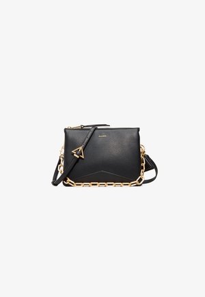 Black leather crossbody bag with a textured finish, gold chain accent, and adjustable strap; features a geometric shape and zipper closure.