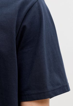 Navy blue cotton t-shirt featuring a crew neckline and short sleeve, showcasing a smooth texture and minimal stitching detail.