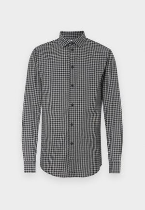 Koszula w czarno-białą kratę z długim rękawem i kołnierzykiem na guziki, o standardowym kroju i zapięciu na guziki z przodu. Materiał o fakturowanej strukturze.