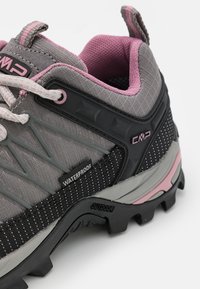 Waterproof hiking shoe with a gray textile upper, pink accents, black rubber sole, and a textured overlay for added grip and durability.