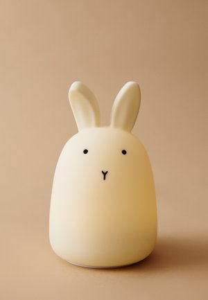 Rabbit-shaped lamp in soft white silicone with black facial accents, round body, and upright ears. Smooth texture, gentle glow effect.