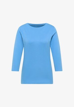 Chemise bleu clair à manches longues, en coton doux, avec un col rond et une coupe droite sans ornements supplémentaires.