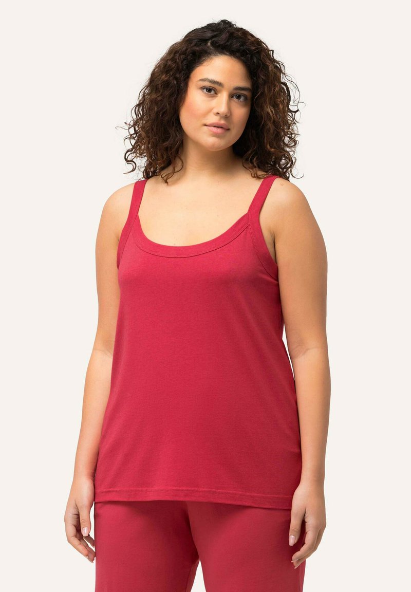 Red sleeveless top made of soft fabric, featuring a scoop neckline and wide straps, paired with matching red pants.