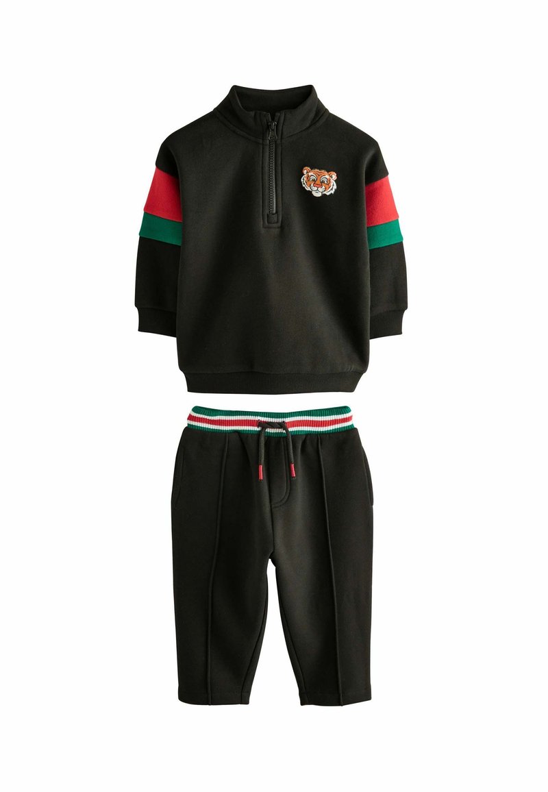 Black cotton tracksuit featuring a zip collar top with a tiger embroidery, red and green stripes on sleeves, and matching drawstring shorts.