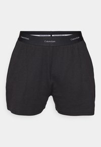 Zwarte katoenen shorts met een elastische tailleband met het "Calvin Klein" logo. Eenvoudig ontwerp met een ontspannen pasvorm en een gladde textuur.