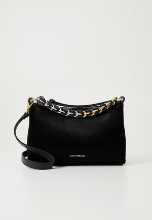 Black leather handbag with a detachable strap and decorative gold and silver chain handles, front embossed with COCCINELLE logo.