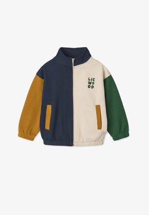 Farveblokeret zip-up jakke i marineblå, beige, grøn og sennepsgul. Har to forlommer og broderet "LIEWOOD" logo. Materiale i bomuldsblanding.