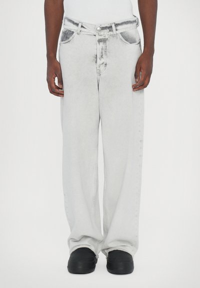 Light gray oversized denim jeans with a faded finish, five pockets, and a button-fly closure. Thick fabric with a smooth texture.