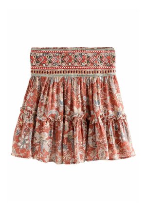 Floral skirt in rust with a smocked waistband, featuring ruffled tiers and intricate embroidery in red, cream, and dark blue accents.