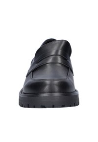 Black leather shoe with a smooth finish, layered strap design, rounded toe, and thick black rubber sole featuring a textured tread pattern.