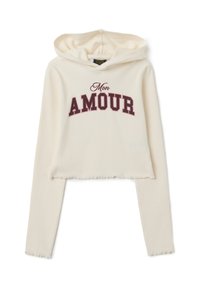 Hoodie court crème en tissu côtelé, avec un graphique « Mon AMOUR » bordeaux. Comprend une capuche avec cordon et un ourlet brut.