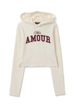 Hoodie court crème en tissu côtelé, avec un graphique « Mon AMOUR » bordeaux. Comprend une capuche avec cordon et un ourlet brut.