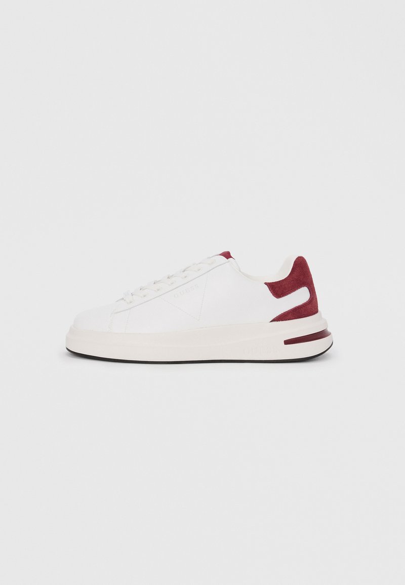 White sneaker with red suede accents, textured upper and rubber sole. Features flat laces and a logo on the side. Minimalist design.